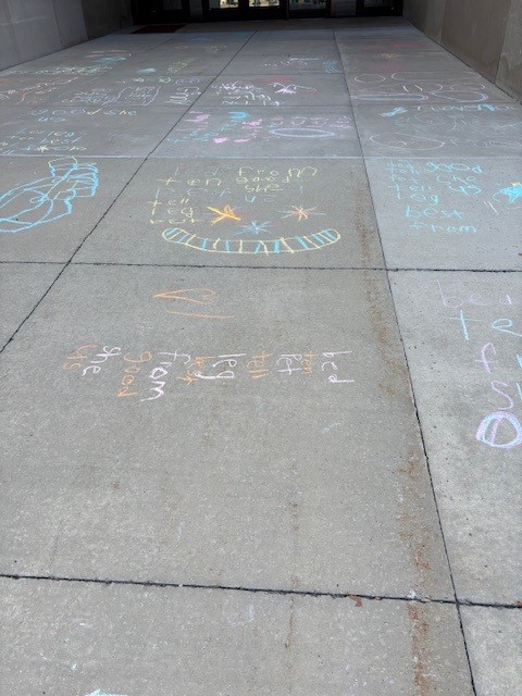 1st grade students practice their spelling words with sidewalk chalk!